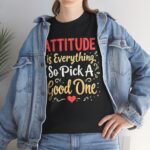 Lifestyle photo of black unisex heavy cotton t-shirt with "Attitude is Everything" design