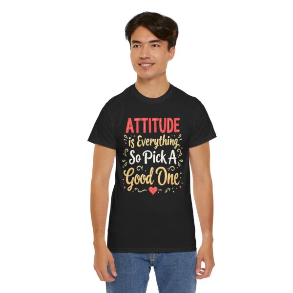 Black unisex heavy cotton t-shirt with "Attitude is Everything" design shown on a man (front view)