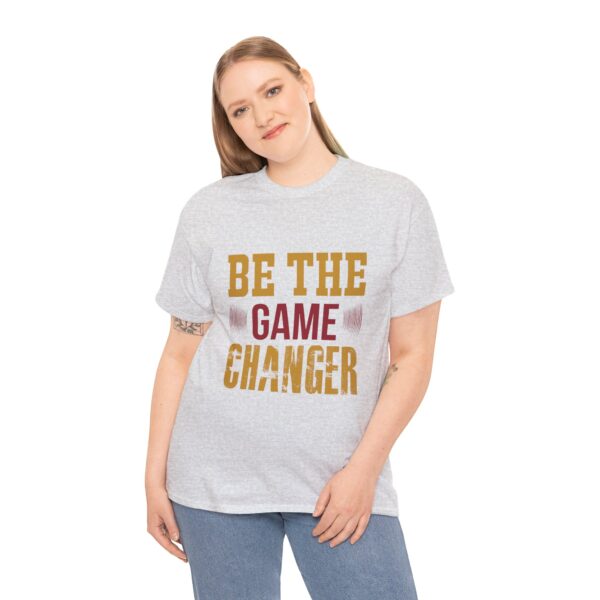 Ash unisex heavy cotton t-shirt with "Be The Game Changer" design shown on a woman (front view)