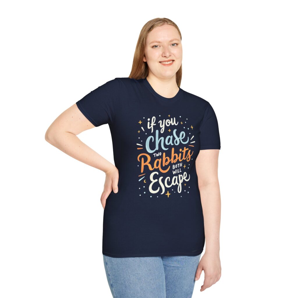 Navy unisex softstyle t-shirt with "Chase Two Rabbits" design shown on a woman (front view)