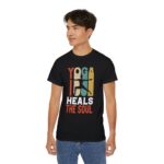 Man wearing black ultra cotton unisex tee with Yoga Heals the Soul design, front view